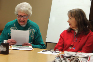 Carol Schlehlein, left, reads a short story she wrote as Trilby Beauprey McIntosh listens during a meeting of the Shawano Area Writers. Schlehlein has self-published two books in the last two years. (Photo by Lee Pulaski)
